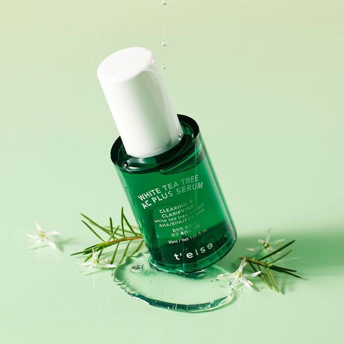 T'ELSE WHite Tea Tree Arc Plus Serum 30ml bottle on green background with tea tree leaves