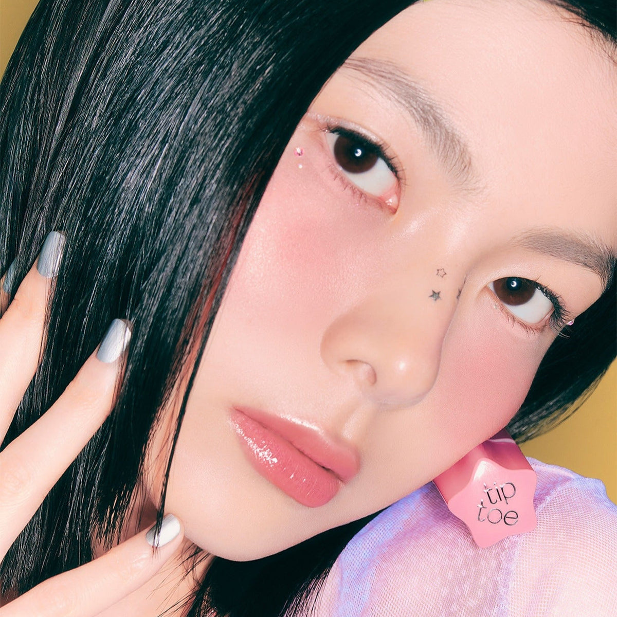Model wearing TIP TOE Glowit Sorbet Tint showcasing a dewy finish and vibrant color on lips and cheeks.
