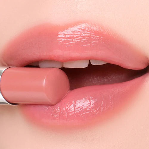 Close-up of lips applying TIP TOE Jelly Stick Plan, highlighting smooth and glossy texture.