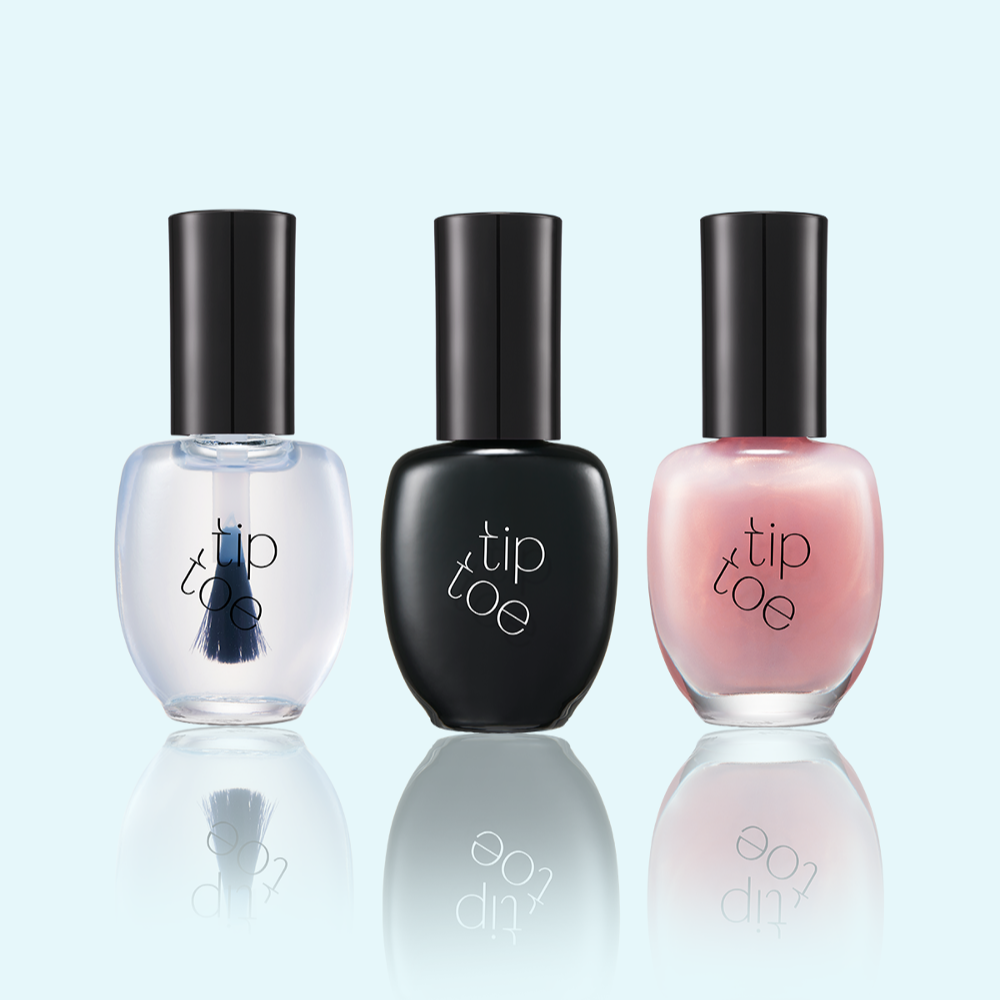 Set of three TIP TOE Sheer Topcoat Nail Polish bottles in different shades on a reflective surface.
