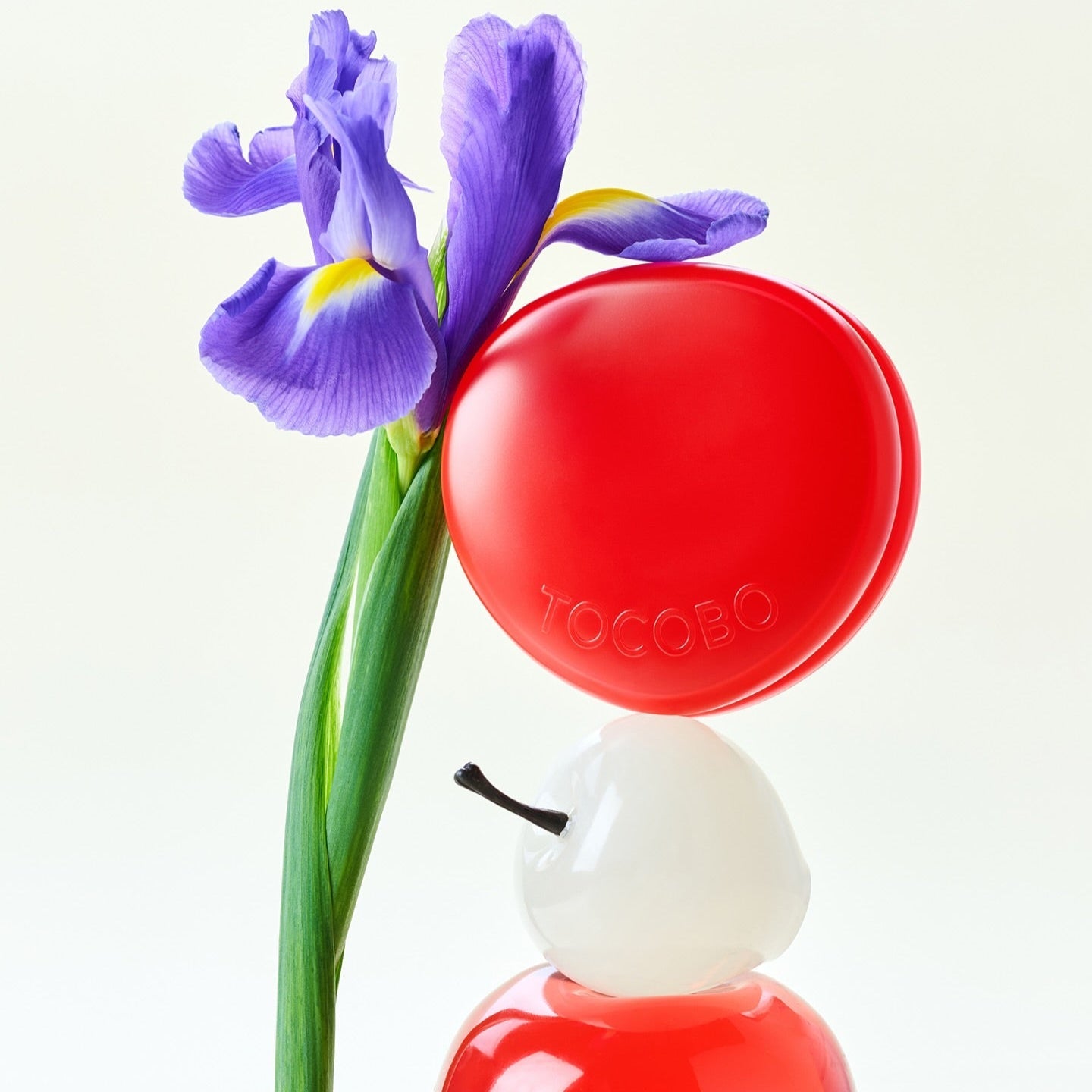 Image of TOCOBO Apple Dewy Fit Cushion with a purple iris flower.