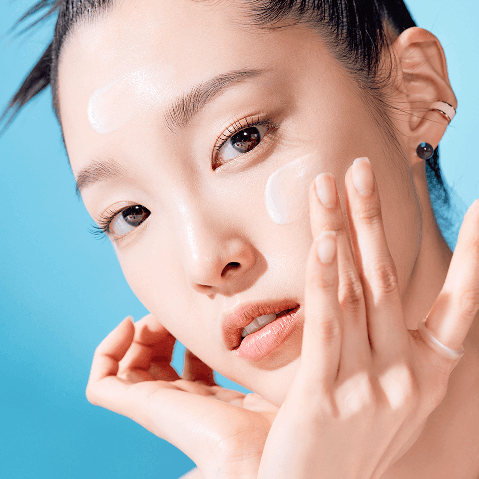 Woman applying TOCOBO Bio Watery Sun Cream for skincare