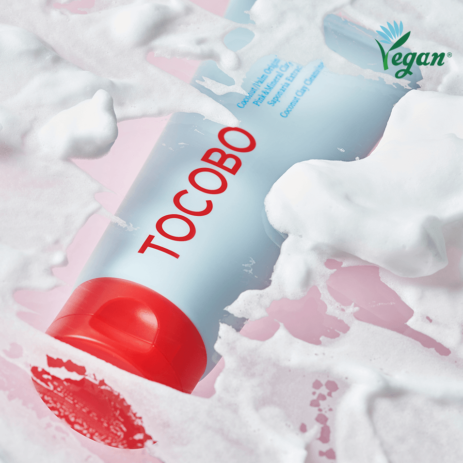 TOCOBO Coconut Clay Cleansing Foam with vegan label, creamy texture and bubbles on pink surface