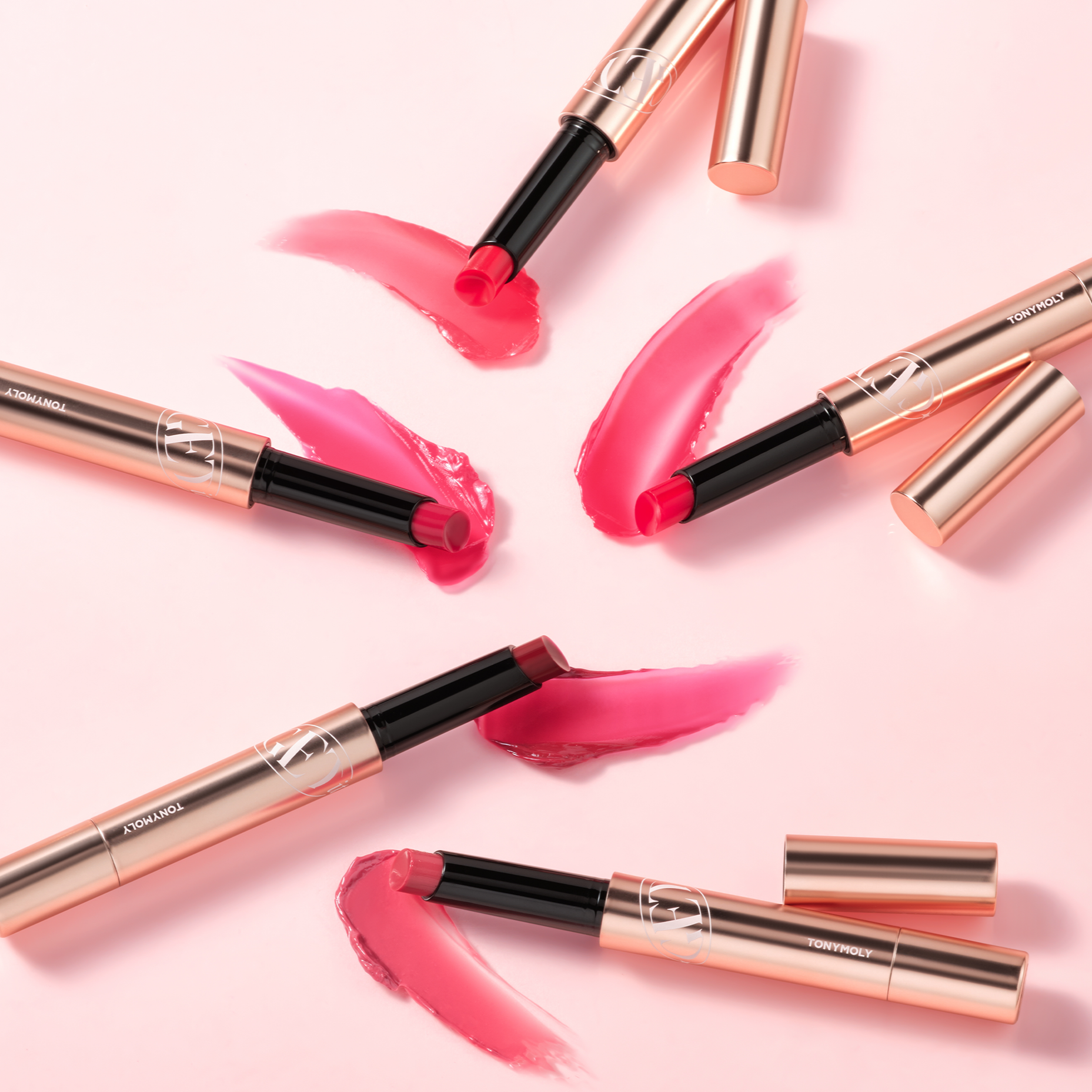 TONY MOLY Get It Tint Glaze Balm in various shades on pink background