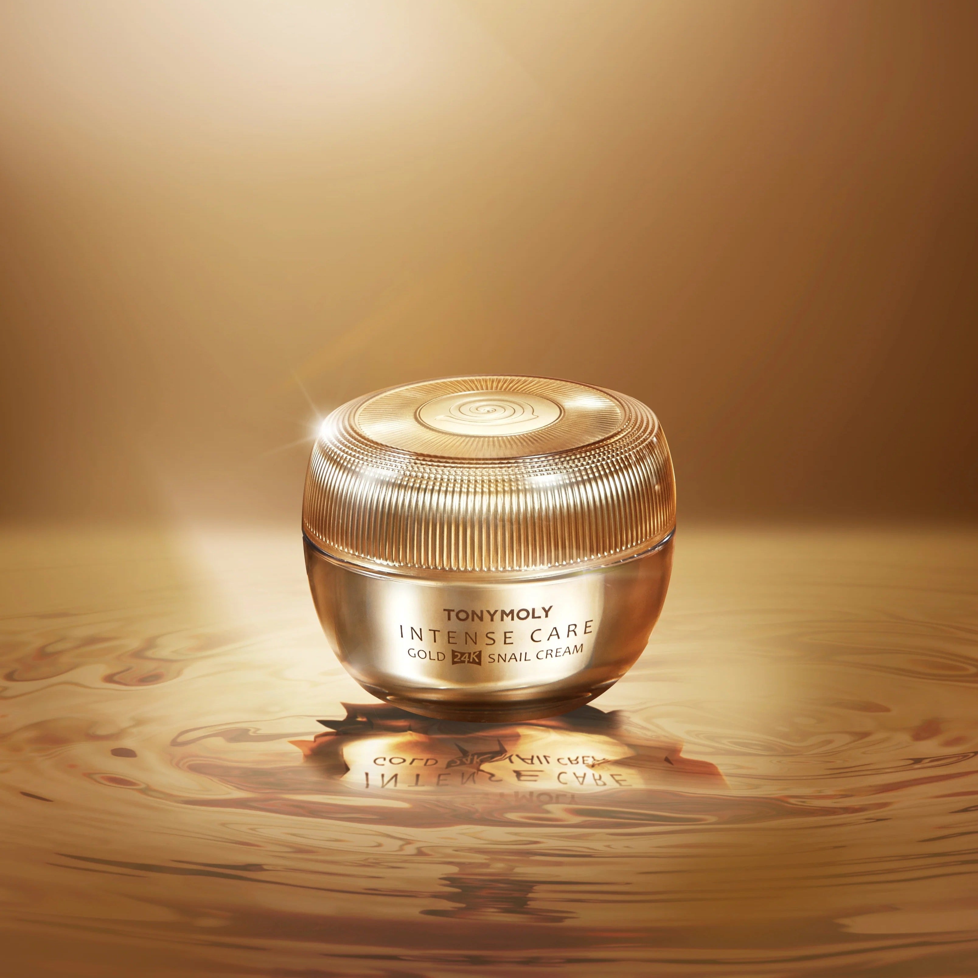 TONYMOLY Intense Care Gold24K Snail Cream 45ml jar on a glossy gold surface