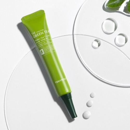 TONYMOLY More Moist Green Tea Moisture Eye Cream 30ml tube on white background with green tea leaves and water drops