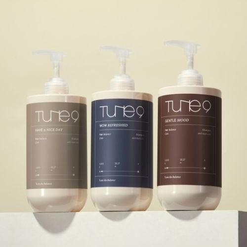 Three bottles of TONYMOLY Tune 9 Wow Refreshing Shampoo 1000g with sleek design on display.