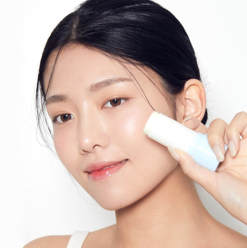 Woman applying TONYMOLY UV Master Mild Moisture Sun Stick 20g on face for sun protection and skincare