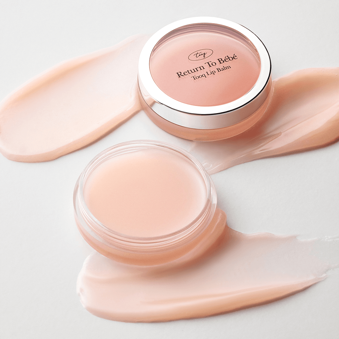 TOOQ Return To BÃ¨bÃ¨ Lip Balm in open containers with smooth creamy texture.