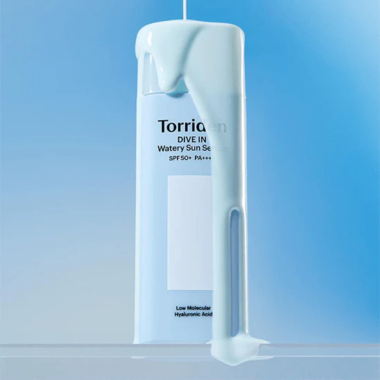 TORRIDEN Dive In Watery Sun Serum SPF50+PA++++ 50ml bottle with product spilling over, blue background.