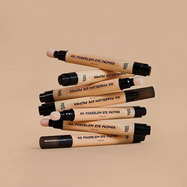 TOUCH IN SOL No Poreblem Eye Primer 4ml tubes arranged aesthetically on a beige background.