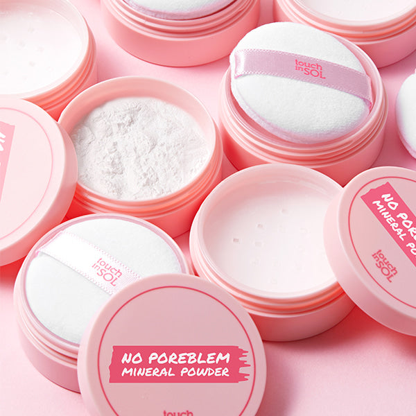 TOUCH IN SOL No Poreblem Mineral Powder 5g displayed in open containers with application puffs on a pink background.