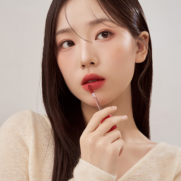 Woman applying TOUCH IN SOL Vegan Again Blurcore Lip Tint