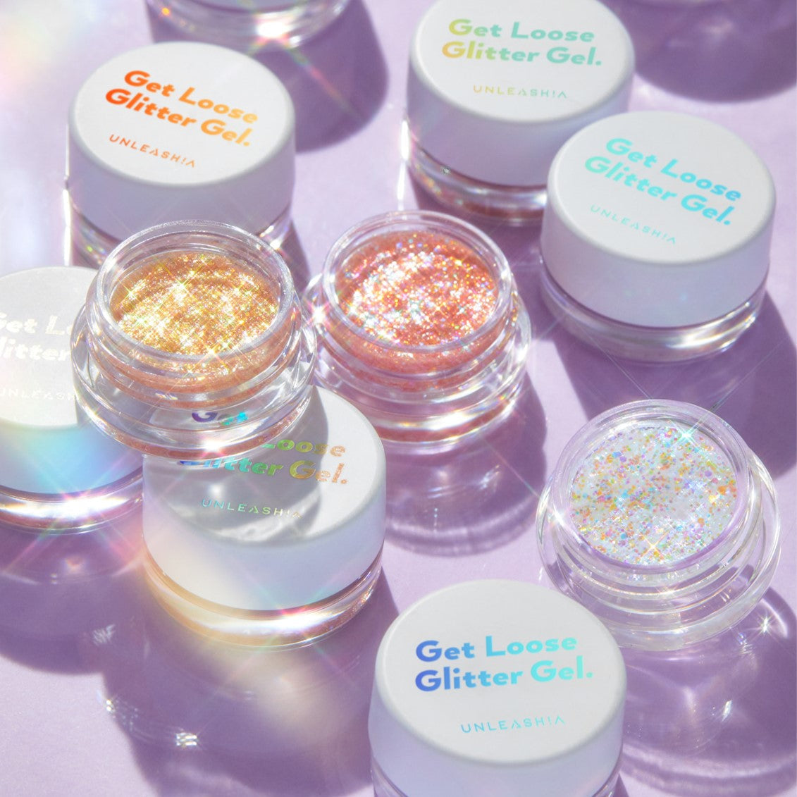 UNLEASHIA Get Loose Glitter Gel (#01 to #07) showcasing vibrant, shimmering glitter shades in clear containers on a reflective surface.