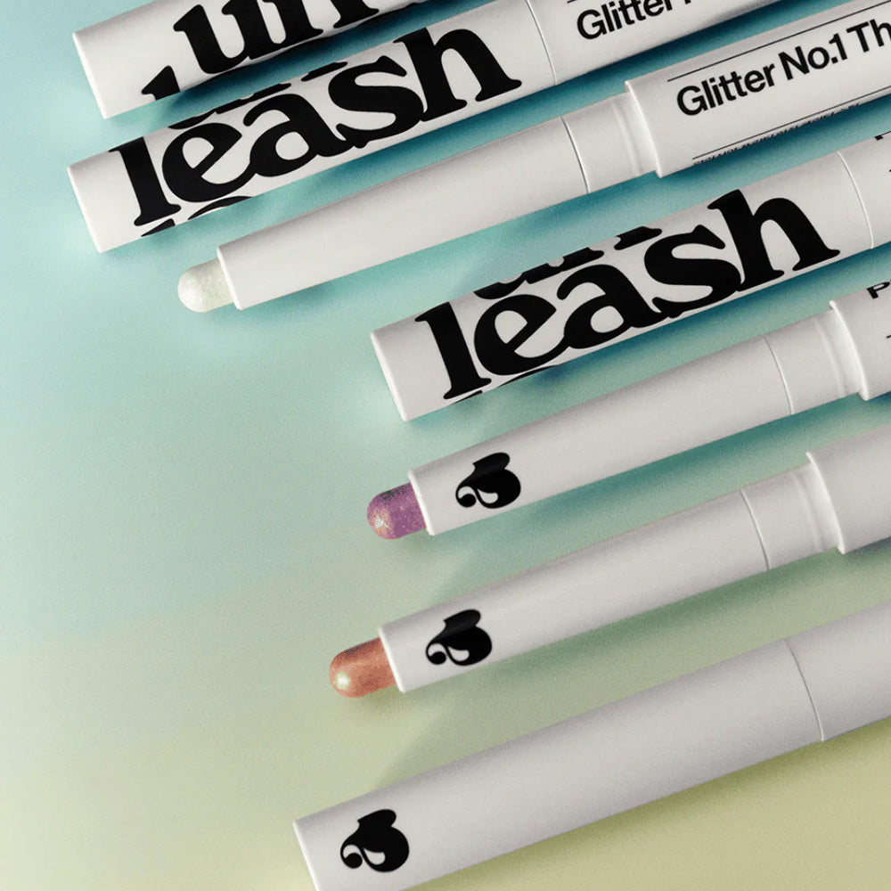 UNLEASHIA Pretty Easy Glitter Stick makeup collection in multiple colors on gradient background