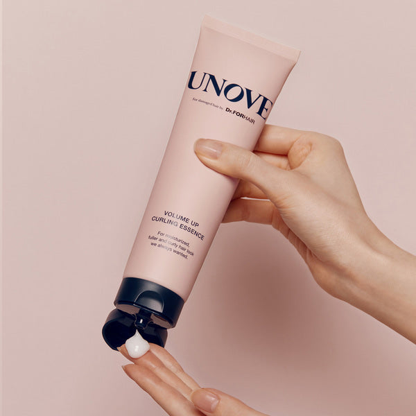 UNOVE Volume Up Curling Essence 147ml bottle held in hand for hair care