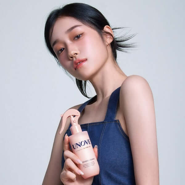 Model holding UNOVE Water Essence Mist 200ml bottle, showcasing elegant packaging and product design.