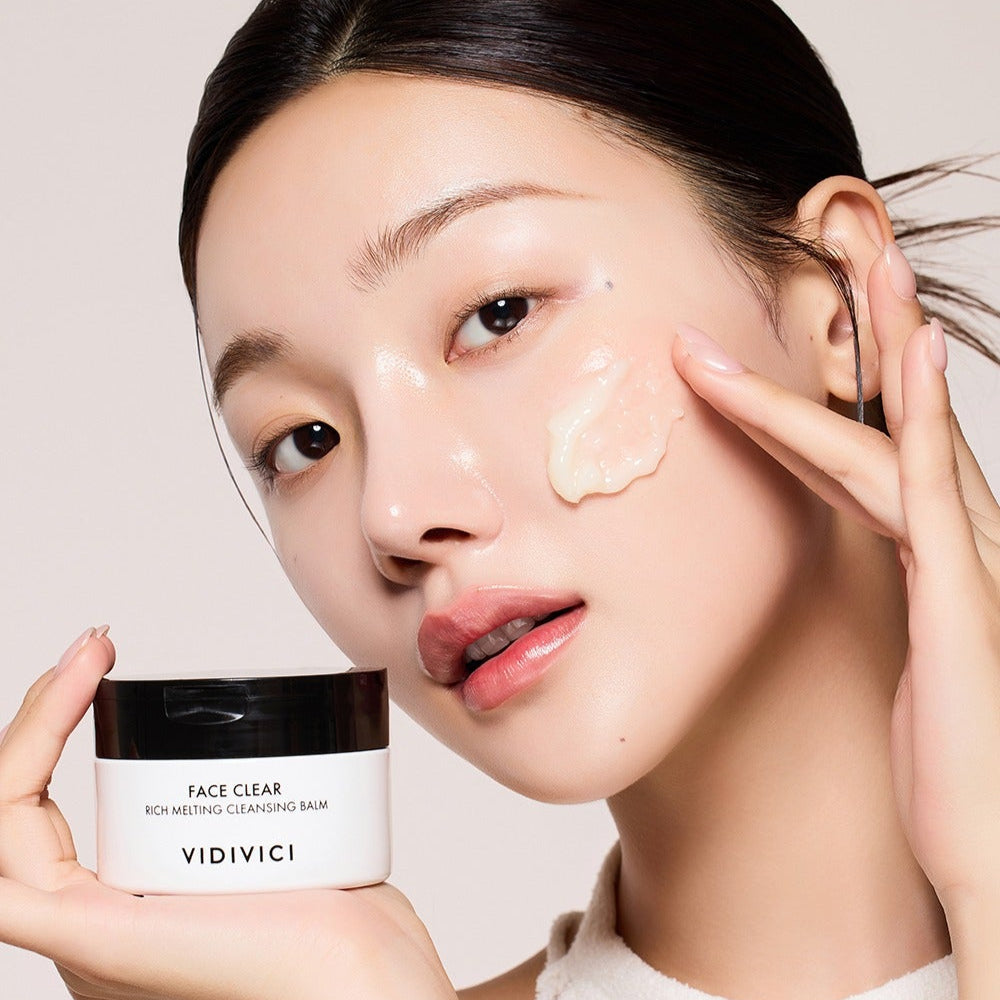 Model applying VIDIVICI Face Clear Rich Melting Cleansing Balm 100ml on her cheek, demonstrating skincare product effectiveness.