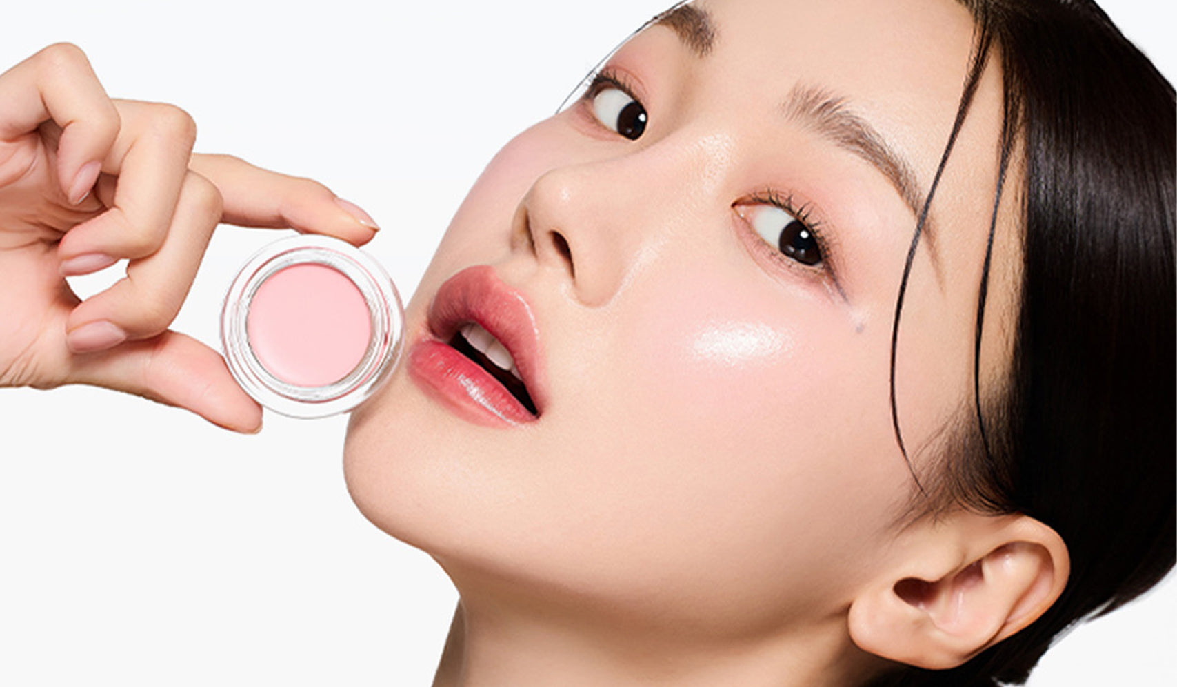 Woman applying pink blush for a natural makeup look