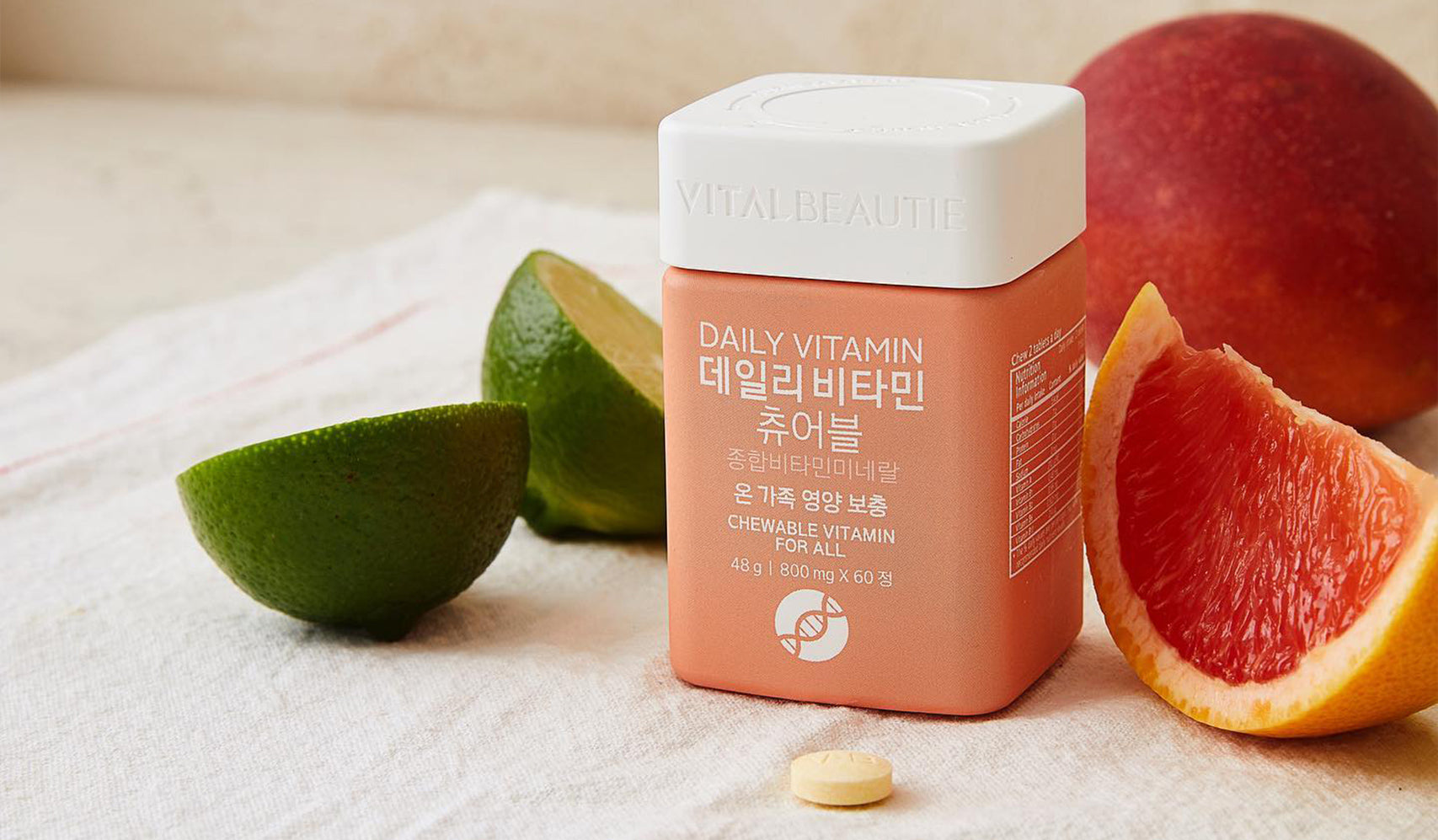 Vitamin supplement bottle with citrus fruits, showing daily vitamin tablets for health.