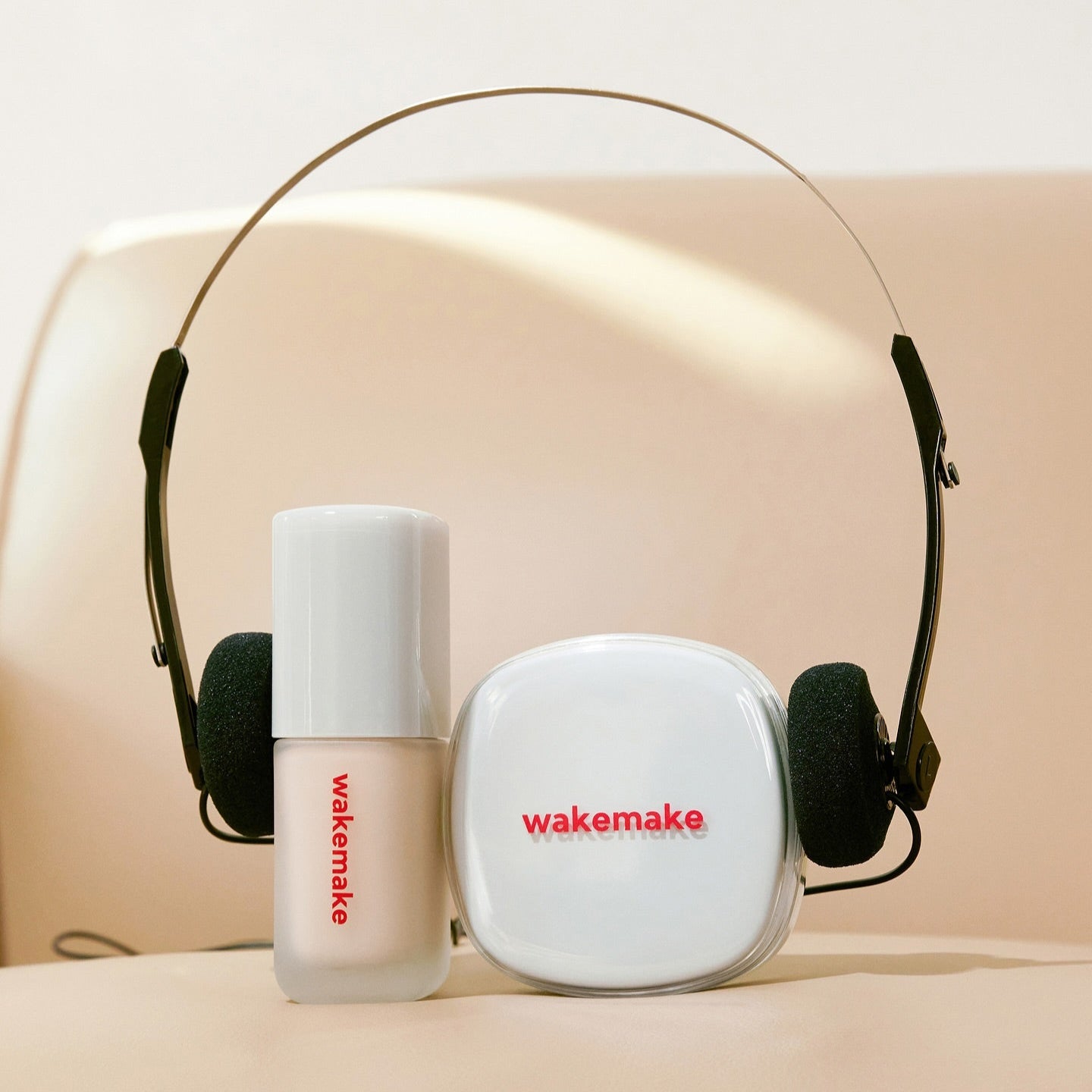 WAKE MAKE Seamless Wear Cushion 15g product display with wakemake branding on headphones and makeup packaging