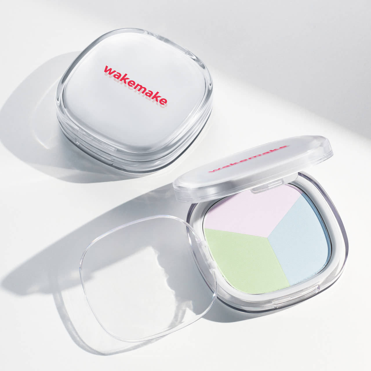 WAKE MAKE Stay Fixer Multi Color Patc 8.6g compact open with pastel color sections and closed compact on white background.