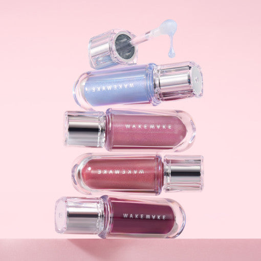 WAKEMAKE Dewy Gel Maxi Gloss in various shades displayed on a pink background