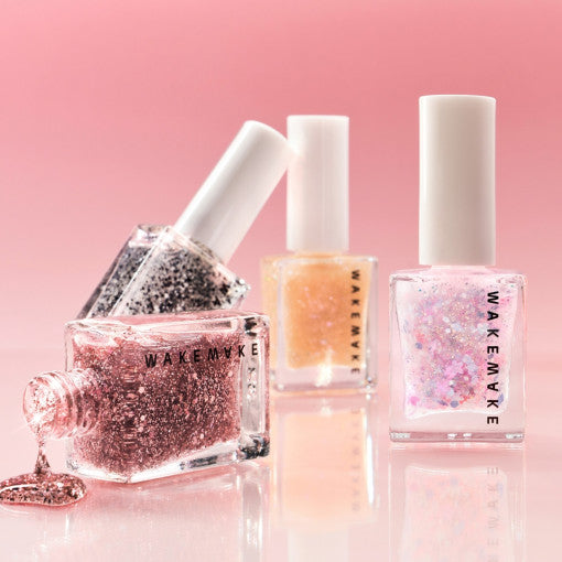 WAKEMAKE Nail Gun #Glitter (#47 to #55) bottles showcased with sparkling finishes on a pink background.