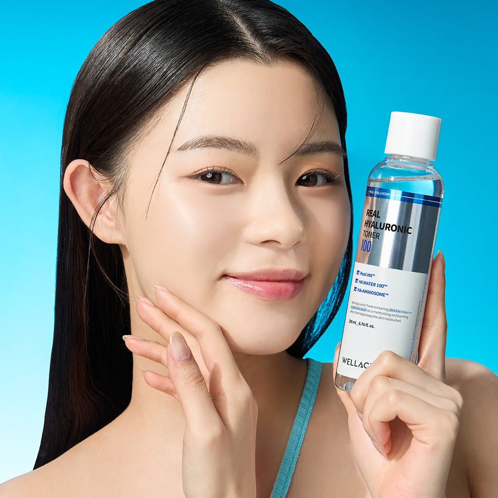 Woman holding WELLAGE Real Hyaluronic 100 Toner 200ml bottle with clear skin