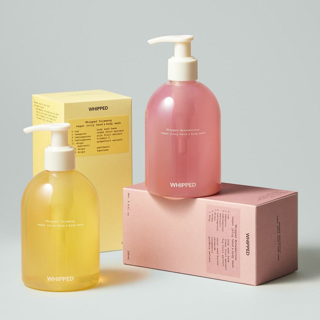 Two bottles of WHIPPED Yujamong Vegan Juicy Hand & Body Wash 290ml with packaging.