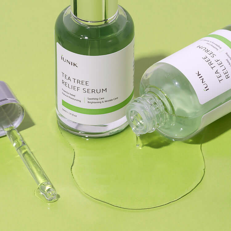 iUNIK Tea Tree Relief Serum 50ml bottles displayed with pipette on green surface