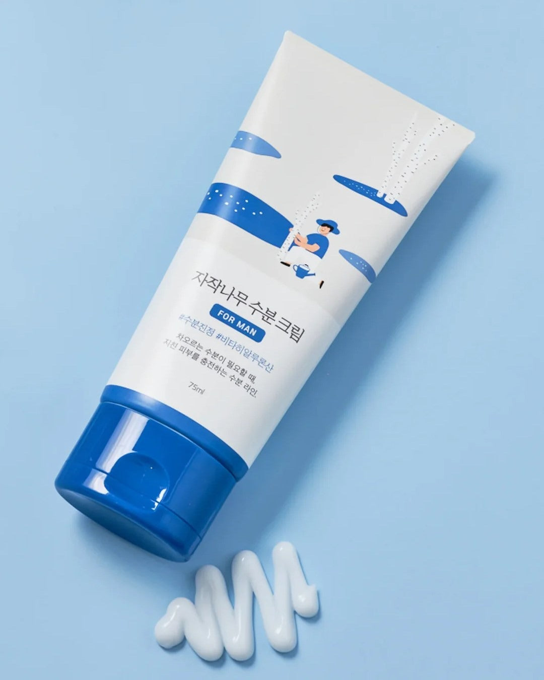 Men's skincare cream tube with blue and white packaging on a light blue background, shown with a sample of cream.