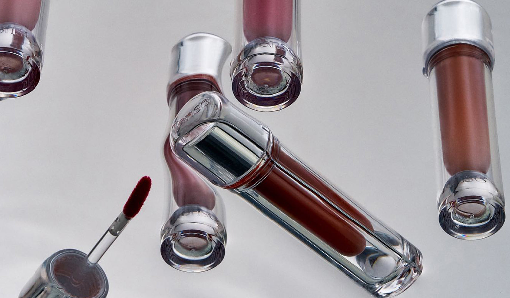 Assorted shades of liquid lipstick tubes with applicator on display, featuring various colors for beauty and makeup enthusiasts.